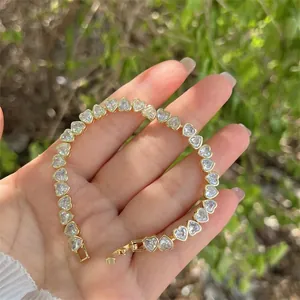 Elegant 18K gold plated heart tennis bracelet with cubic zirconia on female wrist