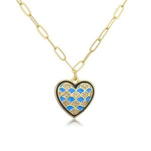 Detail of 18K gold plated heart necklace with blue enamel and sparkling zircon inlay