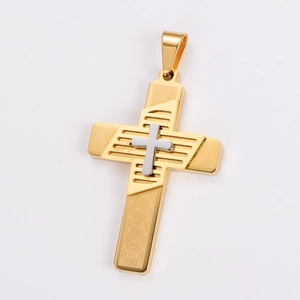 Macro detail of two-tone gold and silver cross pendant with geometric textured relief