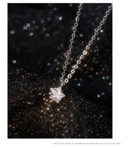 Macro view of a sparkling star pendant necklace with mirror silver finish and O-chain