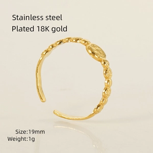Detailed macro view of 18K gold plated stainless steel ring with floral texture details