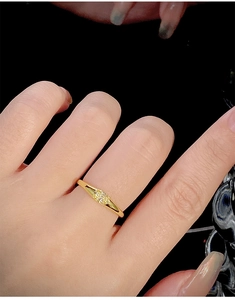Detail of minimalist S925 silver ring with yellow square gemstone on finger