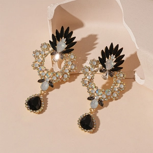 Vintage gold drop earrings with black teardrop crystal and rhinestone floral wreath