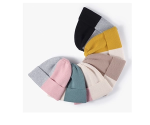 Macro shot of assorted colorful ribbed knit wool beanies in a soft fanned arrangement