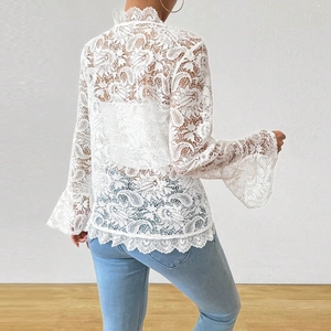 Back view of white lace top with intricate crochet floral patterns and bell sleeves