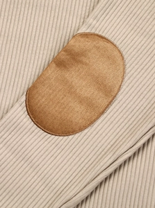 Close-up of ribbed knit texture with suede elbow patches on men's fashion sweatshirt