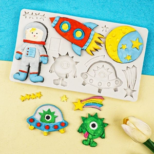Space themed silicone mold featuring astronaut rocket and planet shapes for baking