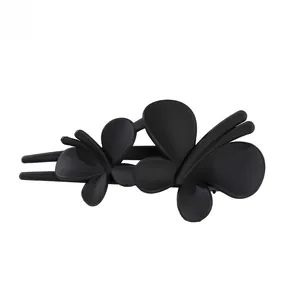 Close-up of a matte black double butterfly hair clip with a smooth duckbill clamp base