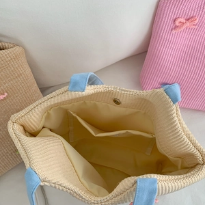 Close-up of woven shoulder bag with fabric lining, inner pocket and magnetic closure