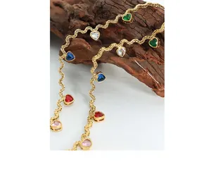 Detailed close-up of golden rope chain necklace with colorful heart-shaped zircon charms