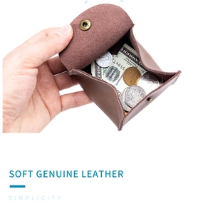 Detailed view of the brown genuine leather coin purse interior holding coins and cash