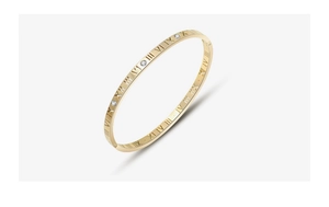 Close-up of gold titanium steel bangle with Roman numerals and diamond-like inlay details