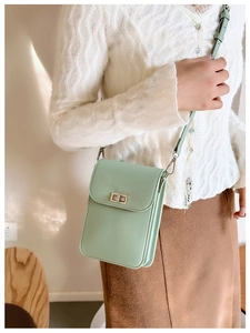 Detail of mint green crossbody phone bag with crossgrain leather and gold turn-lock