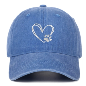 Detail of white double heart and paw embroidery on blue washed denim baseball cap