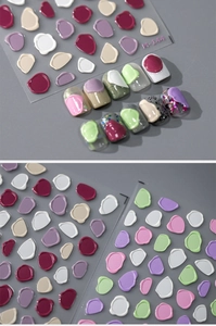 Close-up of 3D embossed nail stickers in various colors with irregular wax seal patterns