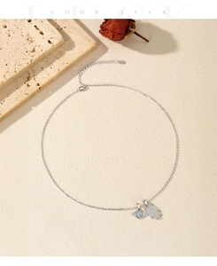 Close-up of S925 silver necklace with sparkling Evil Eye and Hamsa Hand charms