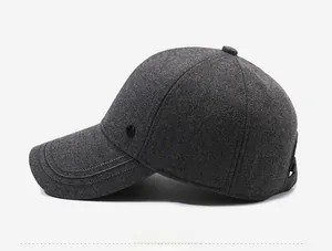 Detail view of dark grey winter baseball cap showing thick wool texture and side metal buckle