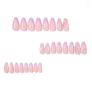 Glossy almond press-on nails with purple French tips and daisy floral designs