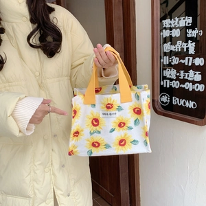Close-up of portable sunflower canvas lunch bag with yellow handles and Korean label