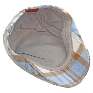 Detailed top-down view of men's plaid beret cap with grey fabric lining and leather label