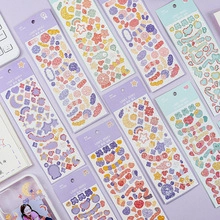 Close-up of pastel aesthetic journal stickers featuring stars, moons and cute bow patterns