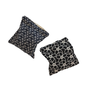 Black cotton drawstring pouches with white floral lace embroidery for makeup storage
