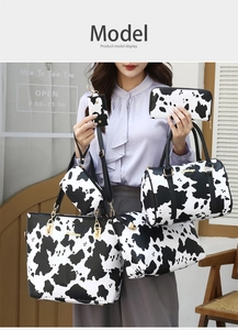 Detailed cow print 5-piece bag set including tote and crossbody on model in outdoor setting
