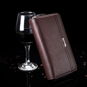 Detail of dark brown leather wallet with lychee texture and silver zipper accent