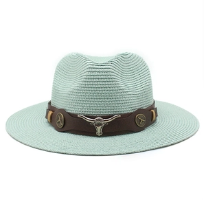 Close-up of mint green straw hat with vintage western leather band and bull head buckle