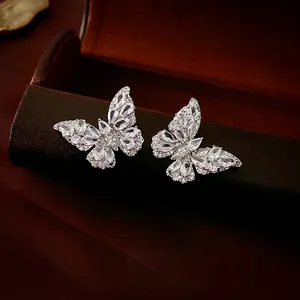 Elegant silver butterfly earrings with sparkling cubic zirconia on a luxury leather box