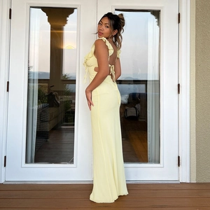 Light yellow backless halter maxi dress with ruffle details and side cut-outs for women