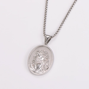 Macro detail of silver oval pendant featuring embossed portrait and thorn texture edge