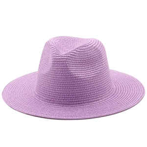 Detail of lavender purple straw fedora hat featuring woven texture and classic wide brim