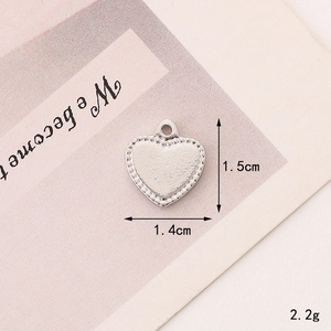 Macro shot of a silver heart-shaped zinc alloy charm with bead edge and 1.5cm x 1.4cm dimensions