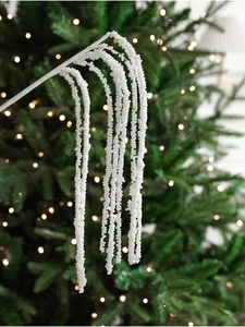 Close-up of white pearl christmas picks with glitter beads on green festive branches