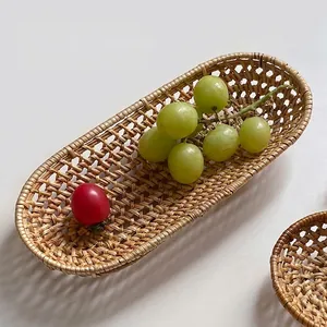 Oval handmade rattan woven fruit basket with natural texture for kitchen storage decor