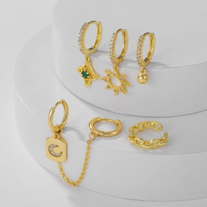 Gold moon and star earring set with zircon fringe chains on a white pedestal