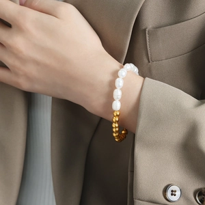 Luxurious freshwater pearl and gold-plated titanium steel beaded bracelet on a model
