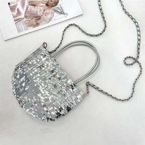 Detail of silver sequin tote bag with metallic chain strap and tubular handles on white background