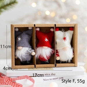 Three Christmas gnomes in a kraft gift box with cozy warm bokeh lighting background