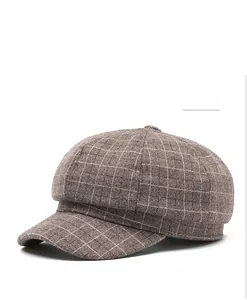 Detailed macro view of the retro wool-like coffee plaid texture on the newsboy cap