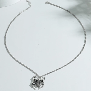 Gothic silver spider pendant necklace with detailed Cuban link chain on white background