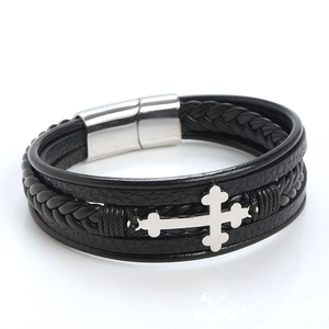 Close-up of black braided leather bracelet with metal cross and magnetic clasp