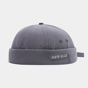 Detailed close-up of dark grey canvas docker cap with white Russian hip-hop embroidery