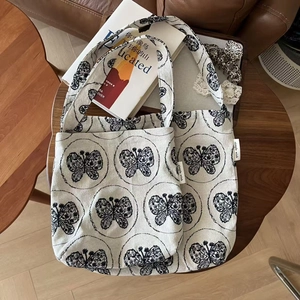 Two-piece set of beige canvas tote bags with elegant butterfly embroidery and shoulder strap