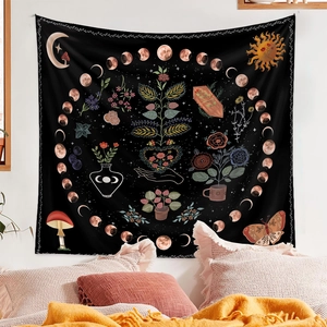 Detail of bohemian tapestry featuring moon phases and mystical elements on bedroom wall