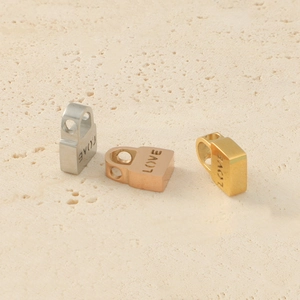 Polished stainless steel LOVE engraved heart beads in silver, rose gold, and gold colors