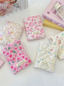 Quilted cotton passport covers with floral and cartoon prints in a soft aesthetic style