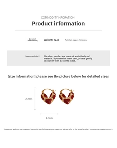 Detailed view of heart-shaped earrings with red oil drip texture and silver needle specs