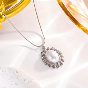Elegant twisted silver necklace with an oval pearl petal pendant and snake bone chain